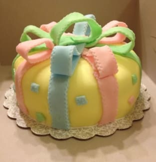 A cake with a bow on top of it.