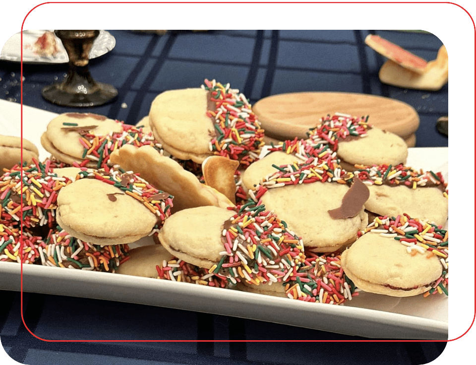 A plate of cookies with sprinkles on top.