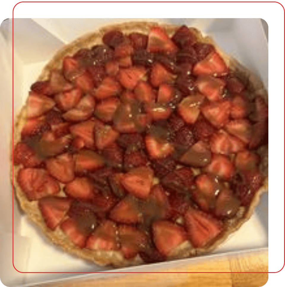 A strawberry pie sitting on top of a box.