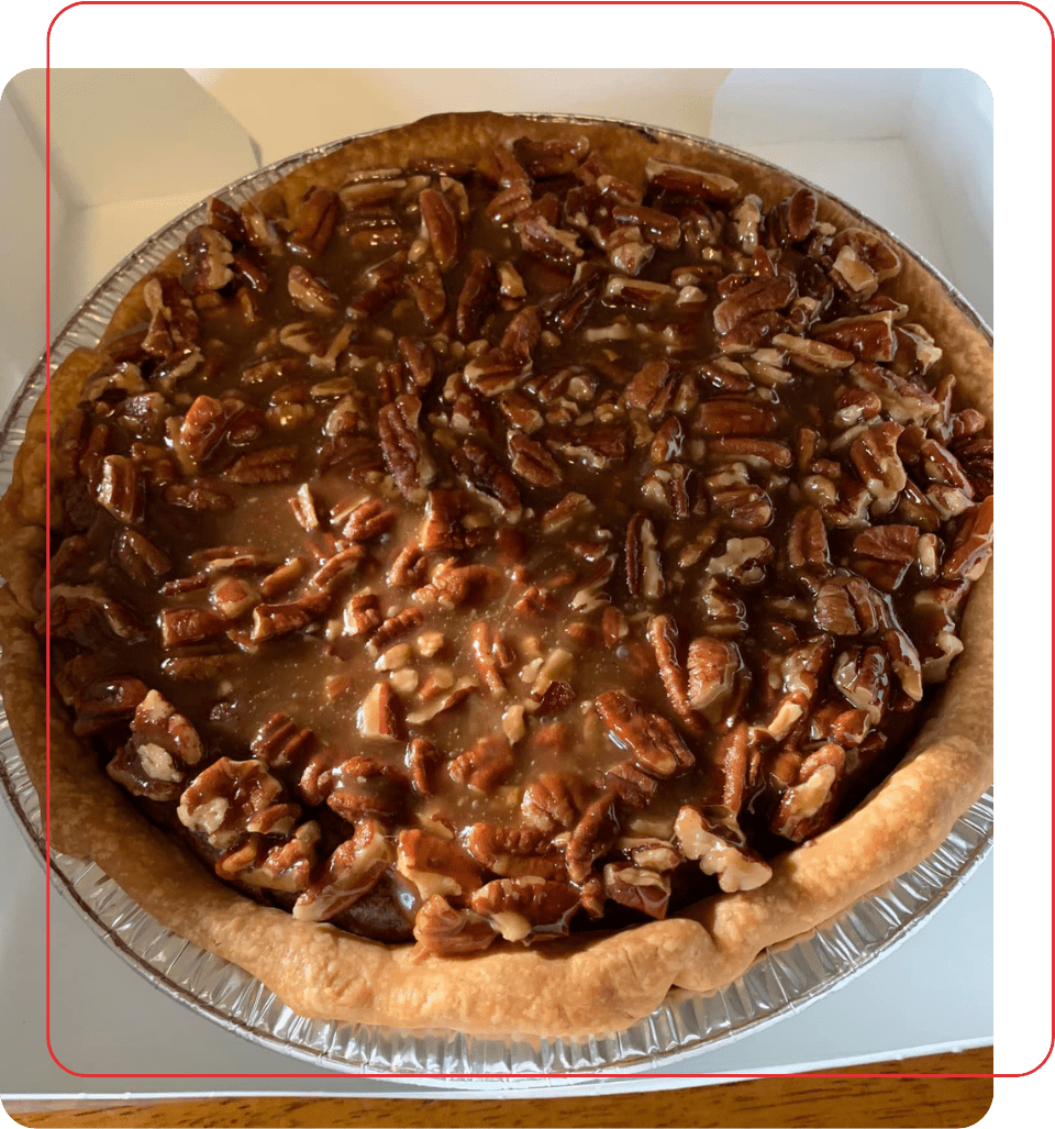 A pie with pecans on top of it.