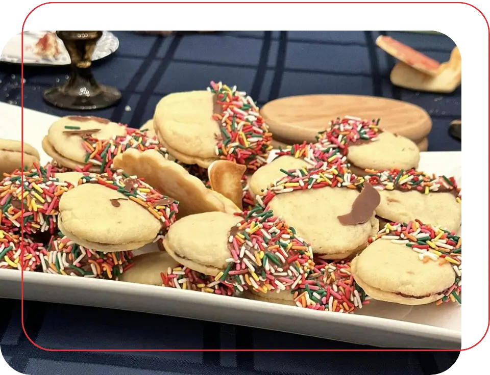 A plate of cookies with sprinkles on top.