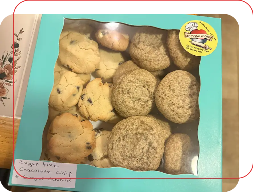 A box of cookies with one cookie in the middle